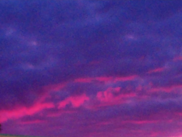 A deep purple evening sky streaked with bands of bright pink cloud over Myrtle Beach