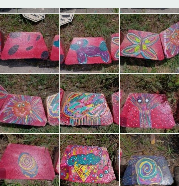 Nine of Mia Roze Bootz's hand-painted garden blocks on a hot-pink ground — a balloon dog, a butterfly, a smiling sun, a rainbow cloud, an ice-cream cone, and spirals in teal, orange, and yellow