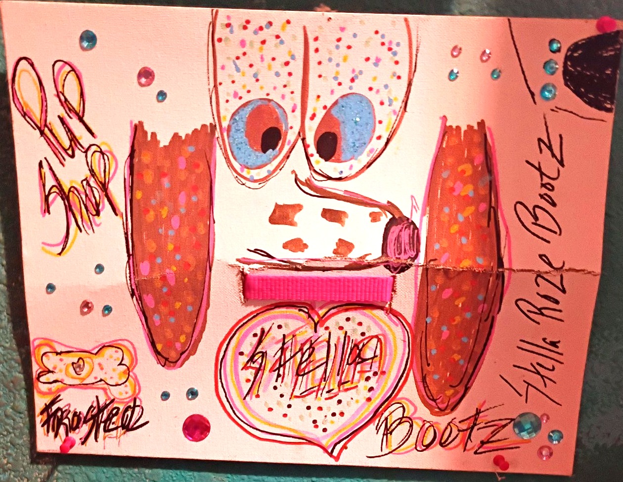 Mia Roze Bootz's hand-painted portrait of Stella Roze Bootz — a pink painting of a dog's face with big blue eyes, long brown speckled ears, a pink collar, her name written inside a heart, and Pup Shop and Frosted lettering, studded with coloured gems